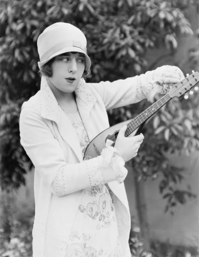 Vintage pic of woman tuning a mandolin