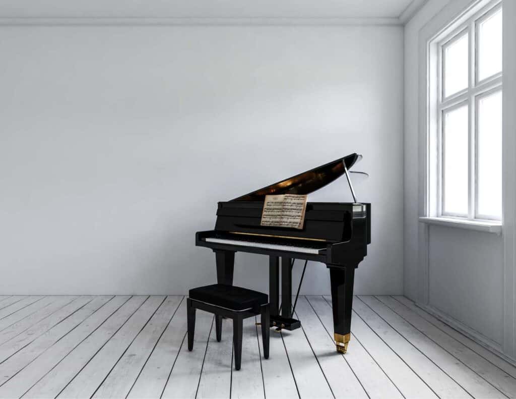 Baby grand piano in white room