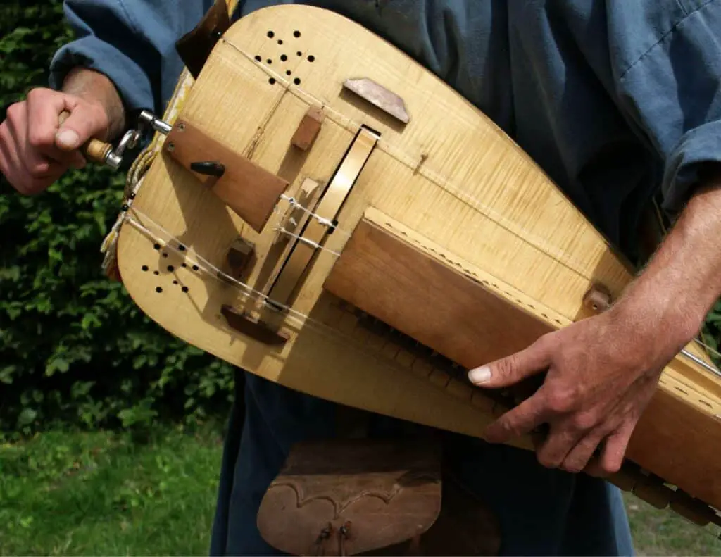 Musician playing a hurdy-gurdy.