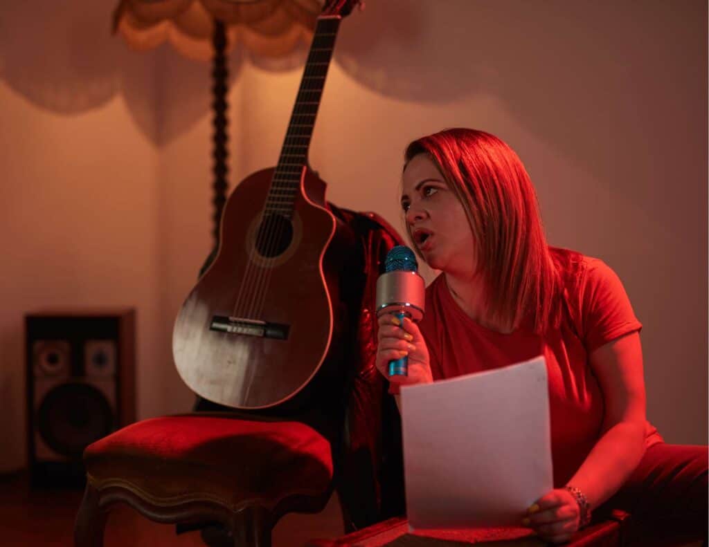 Woman singing into a wireless, handheld microphone